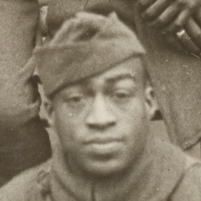 African American Soldier wearing World War One uniform looking at the camera