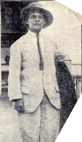 Luisa Capetillo wearing a shirt and tie, light colored suit jacket, matching pants, and wide-brimmed hat