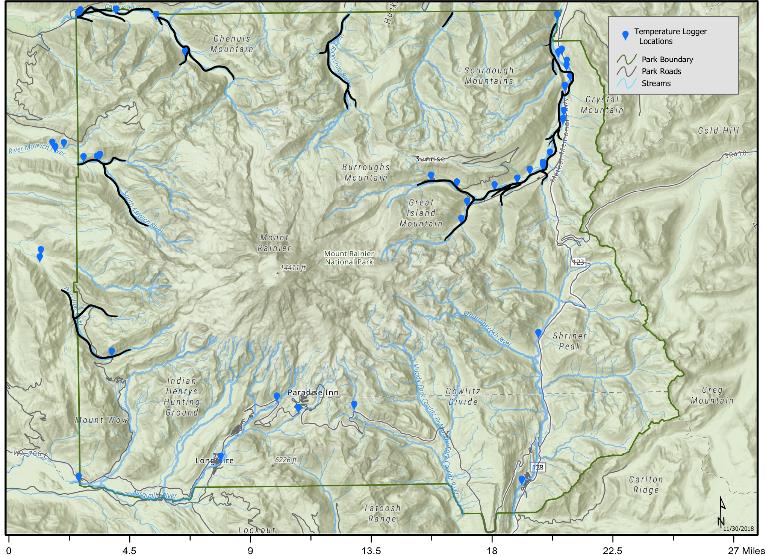 A map of Mount Rainier National Park with streams on the north and west side of the park outlined in black with blue markers along the streams indicating the locations of temperature loggers.