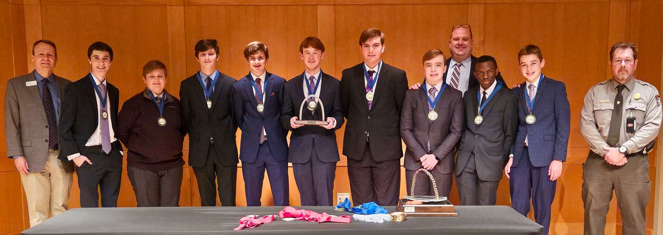 Nine students, two teachers, and a park ranger at an engineering contest.