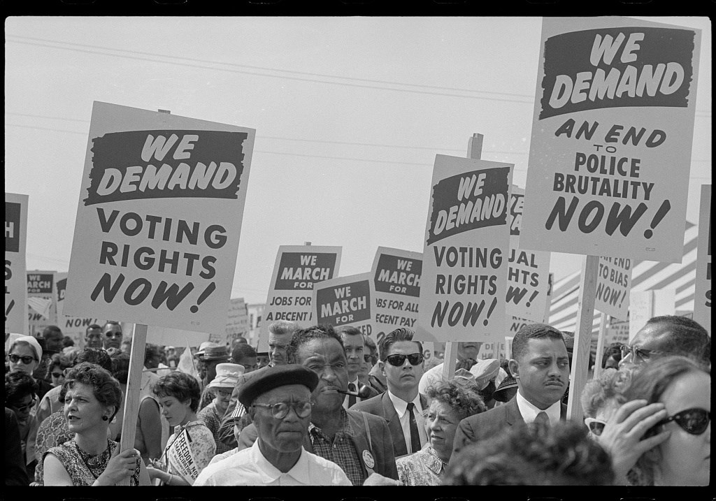 A crowd at the March on Washington in 1963 carrying signs