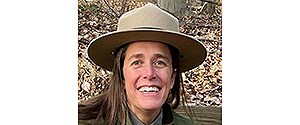 a smiling woman in a national park service uniform