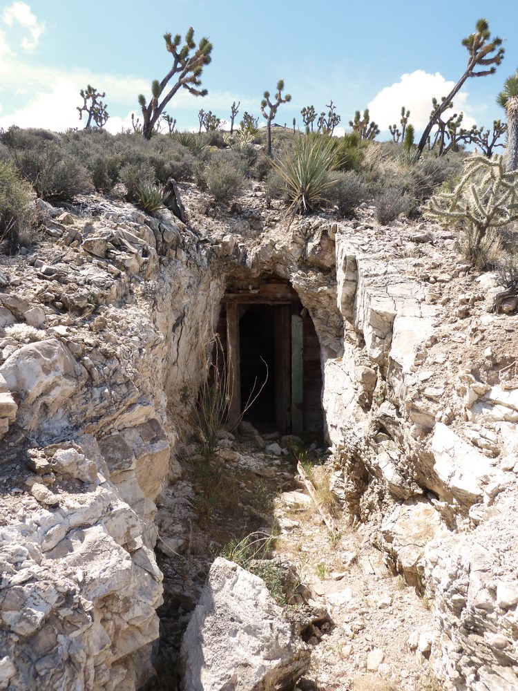 Entrance to a mine surrounded by rocky features
