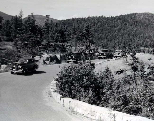 Historic photo of a caravan of vintage automobiles