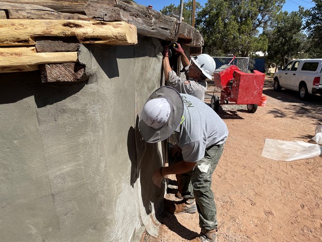 NPS Staff working on the walls of the historic Ranger Hogan