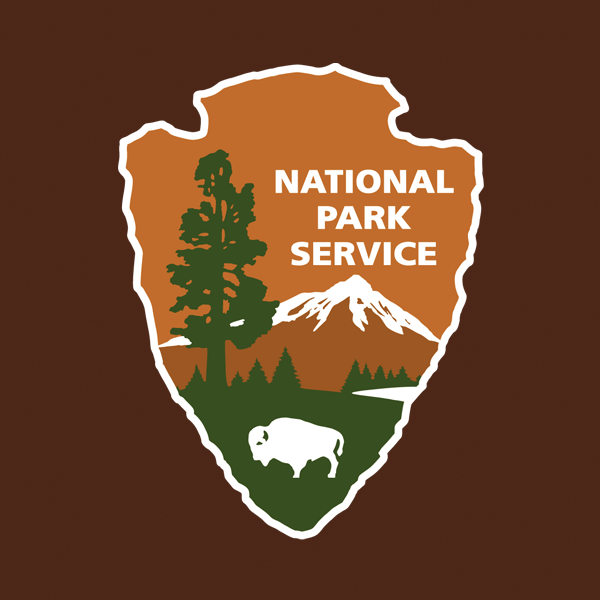 NPS arrowhead with dark brown background