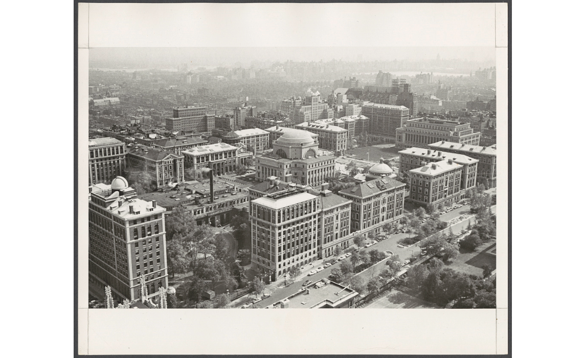 Black and white aerial photo of a dense urban college campus.