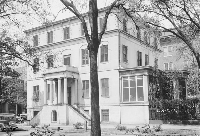 Black and white image of a four-story town house.