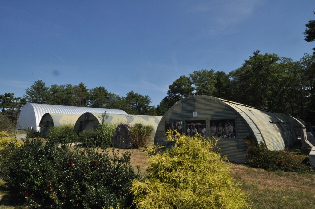 line of long low domed corrugated steel quonset huts