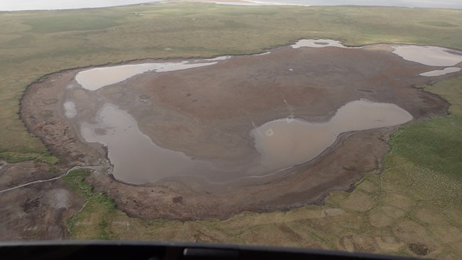 A lake in Bering Land Bridge National Preserve that drained suddenly in 2018 through a channel visible on the lower left side.