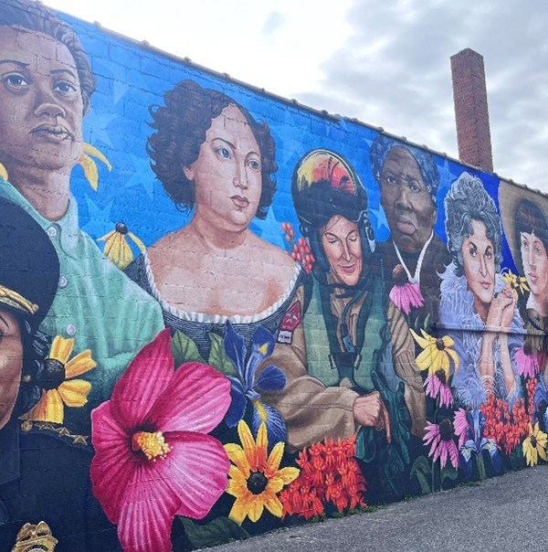 Image of the Dorchester Women's Mural located in Downtown Cambridge, MD. The mural features a dozen women from the past and present who have made a difference in Dorchester County and far beyond.