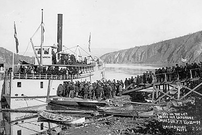 Historical image of men boarding a steamership.