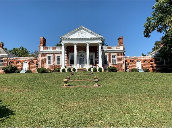 Image of the front view of the Estate House located at the Whitehall site on a clear, sunny day.
