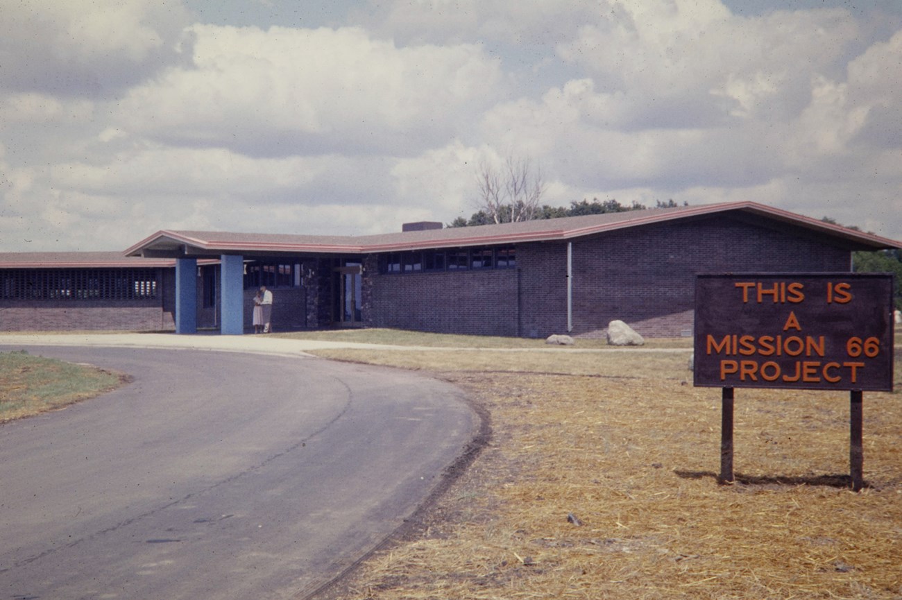 Building with a sign that says "Mission 66"