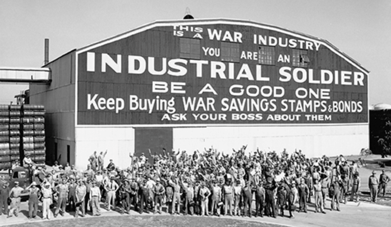 crowd gathered outside hangar building cheering war bond drive