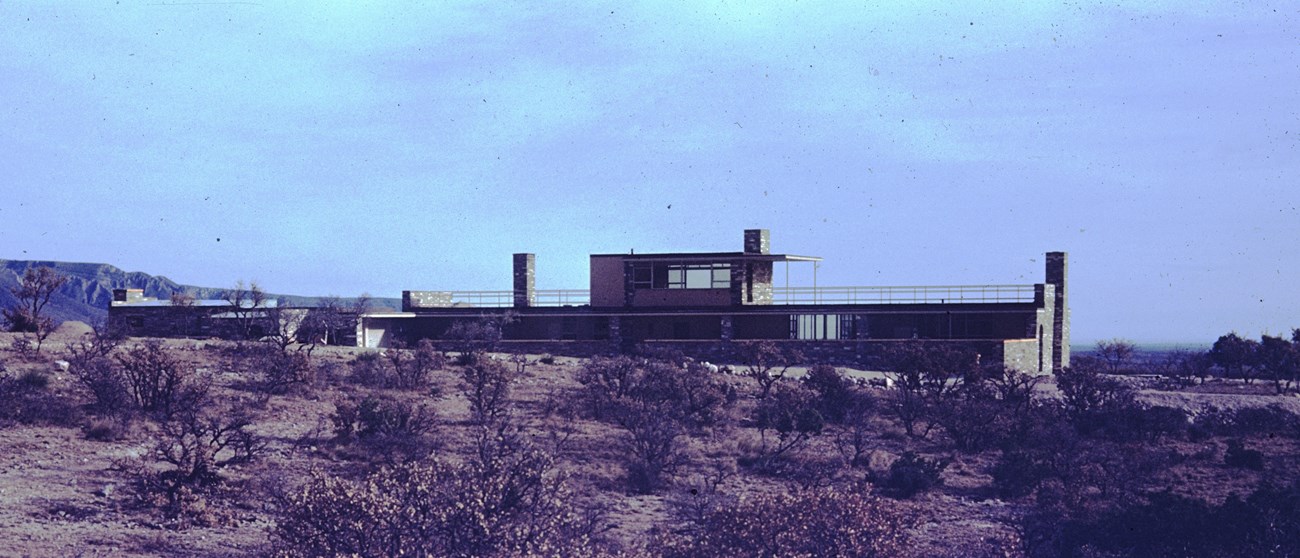 A rectangular home on a desert landscape