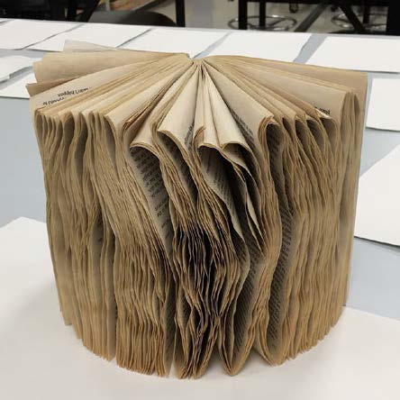 This series of photographs starts by showing how a wet book appears after being dried; the pages are extremely curled and warped and the book cannot be shut.