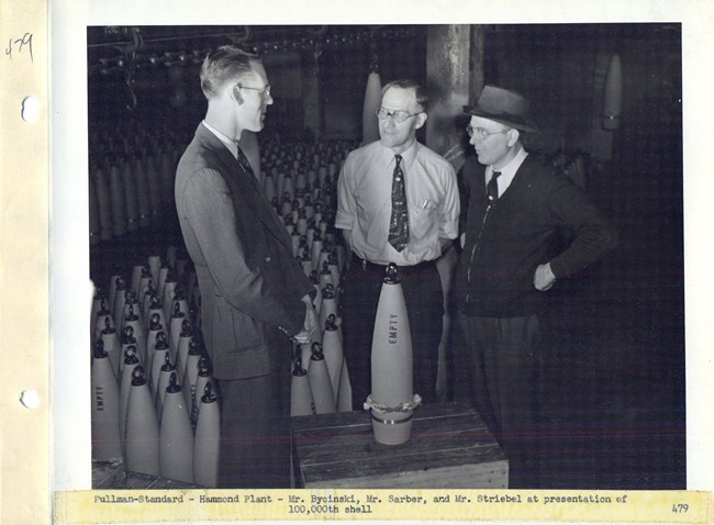 Pullman Standard Hammond Plant. 3 men at a presentation of their 100,000th shell.