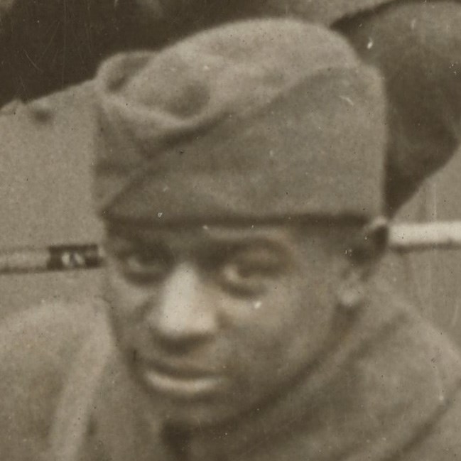 African American Soldier wearing World War One uniform looking at the camera