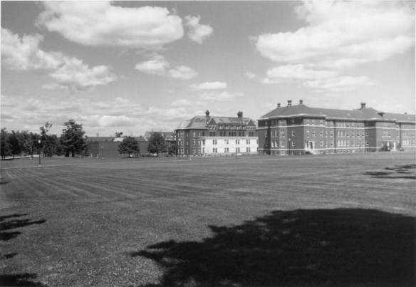 Black and white photograph of two of the buildings in the Maine Insane Hospital complex. The featured building is the ray building.