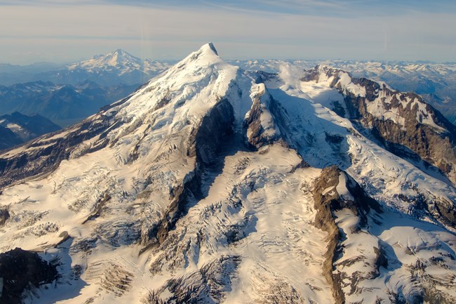 View of two snow capped volcanoes and clear skies.