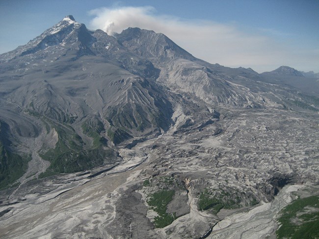 A volcanic mountain with an ash-covered glacier.