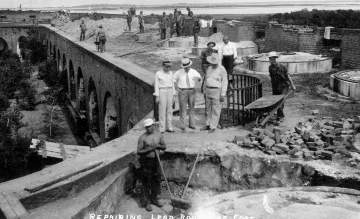 Men standing around excavated terreplein