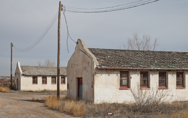 Two deteriorated adobe brick buildings.
