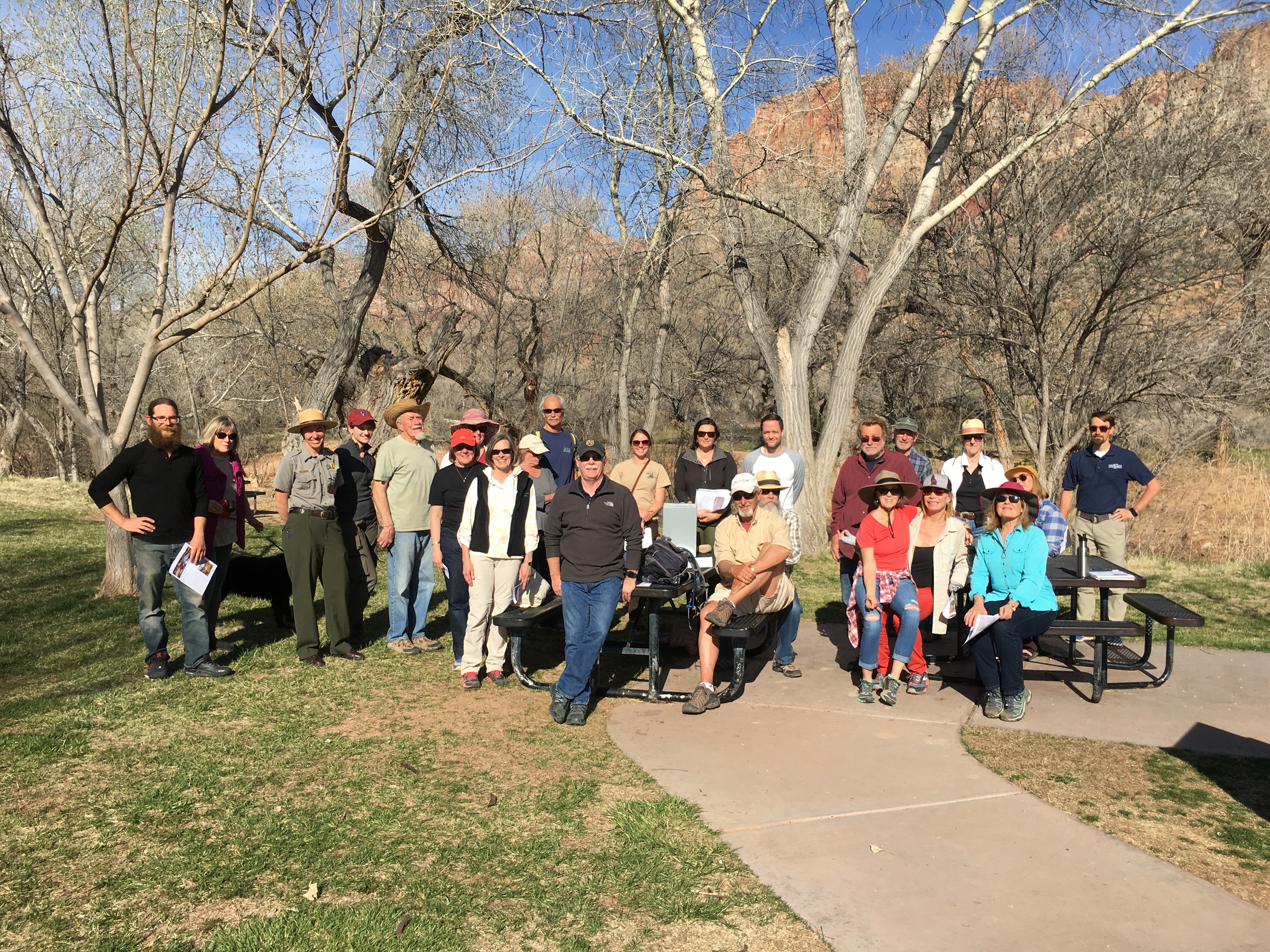 Group of people gathered by the river to celebrate management plan
