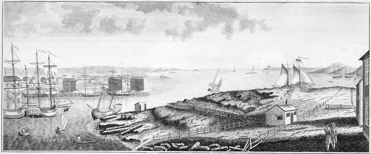 Back and white image of a harbor with ships and buildings lining the shore.