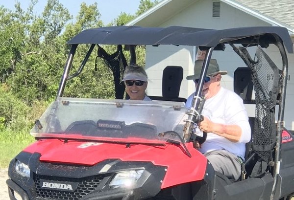 Two members of Canaveral National Seashore Rocket Team riding in an ATV.