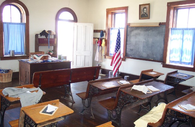 Interior view of Lower Fox Creek Schoolhouse, looking northeast. Room specially outfitted for Education Day program activities.