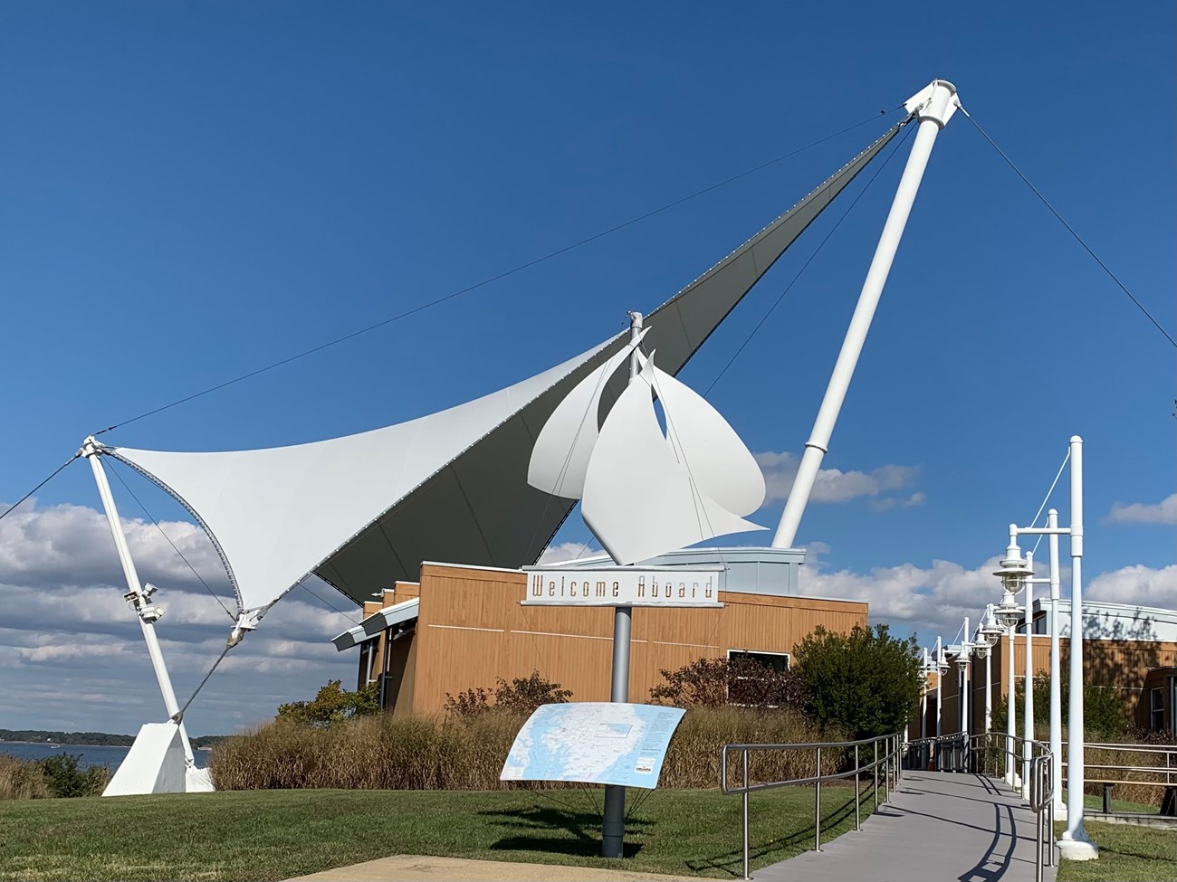 A visitor center with large white canvas tops that looks like sails.