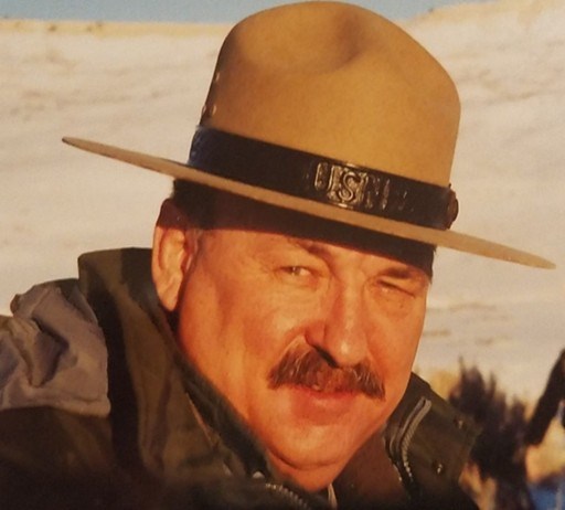 Photograph of a man with a mustache wearing a gray national park ranger flat hat