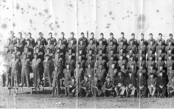 men in military uniforms stand on risers