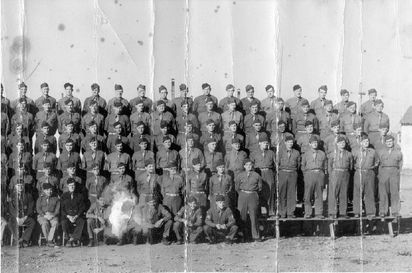 men in military uniforms stand on risers