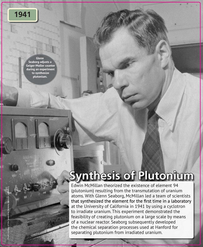 A man with short-cropped dark wearing a long-sleeved white shirt and tie leaning over a piece of electronic equipment.