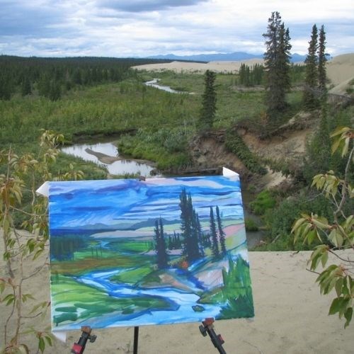 Artwork - a painting of a river and spruce trees - in front of the scenery that inspired it.