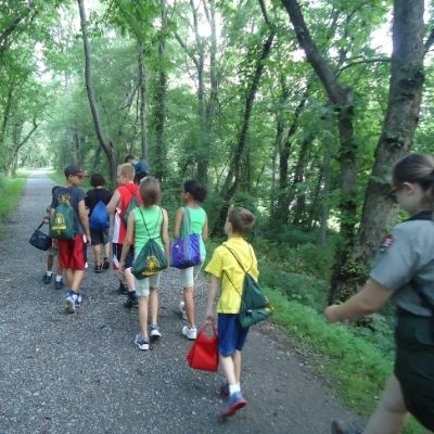 Youth with Park Ranger walking along a trail.