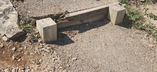 Signs of trail deterioration include broken wooden trail supports.