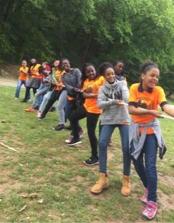 Youth pulling on a rope playing tug-of-war.