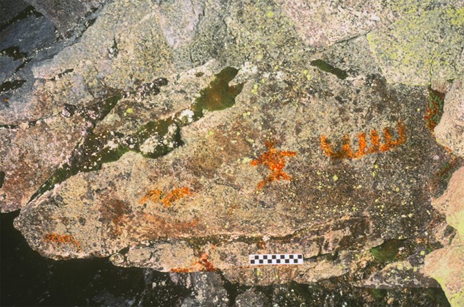 Orange colored pictographs on a rock