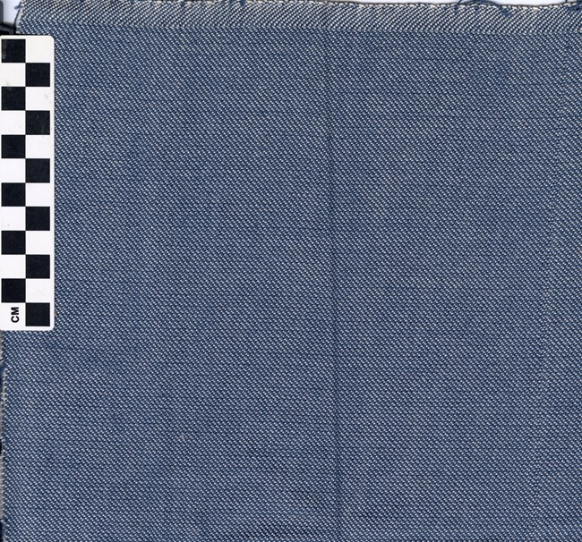 A blue cloth with a pattern that forms diagonal lines running from left to right. The lines alternate between blue and white