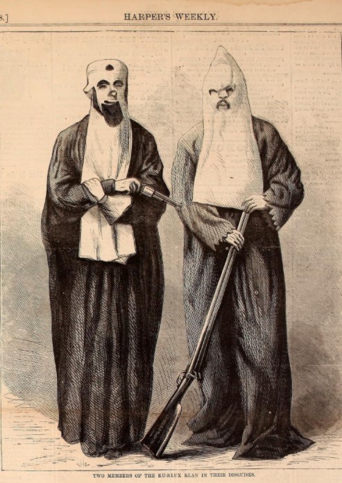 Two members of the Ku Klux Klan wearing robes and white hoods while holding guns.