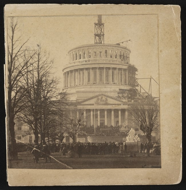 US Capitol half completed with crane above