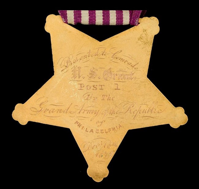Gold five-point star shaped Grand Army of the Republic Badge awarded to U.S. Grant.