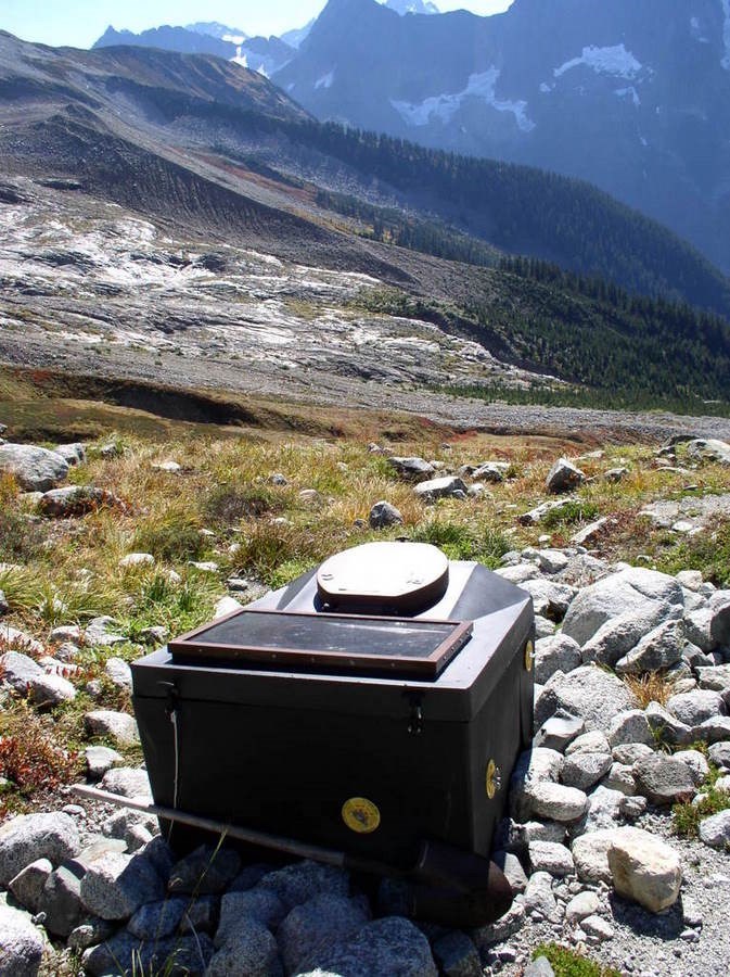 Composting wilderness toilet overlooks a scenic mountain view