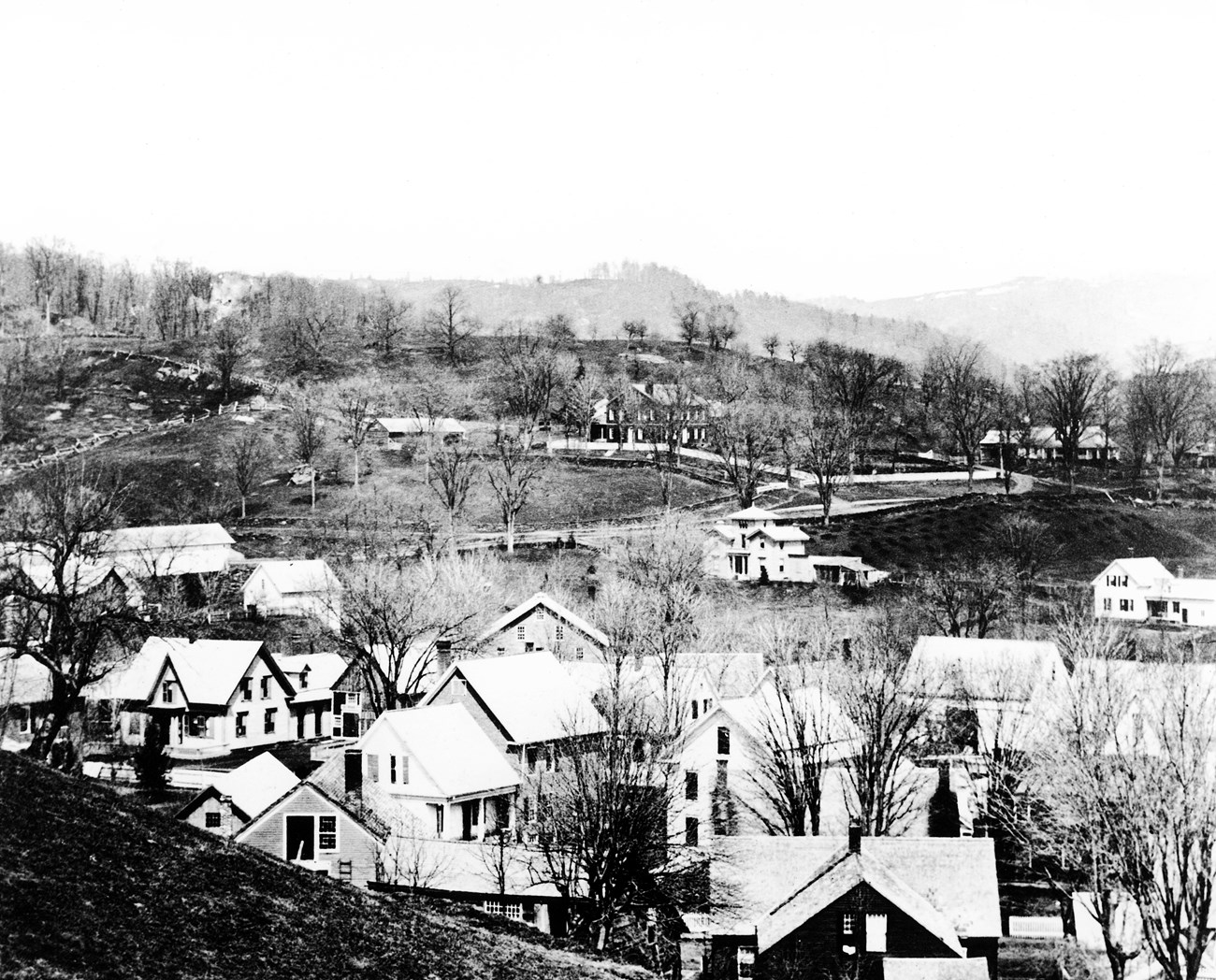 black and white 1869 photo of vermont hillside with Marsh mansion in the distance