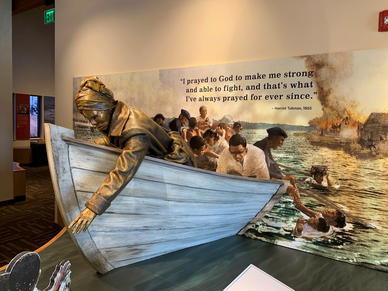 A museum exhibit with a sculpture of Harriet Tubman rescuing people from the water.