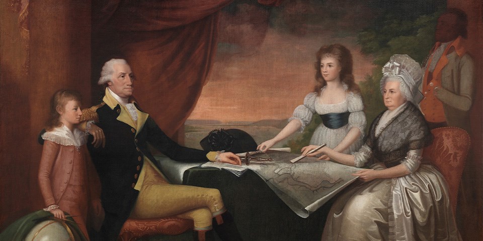 The Washington family seated at a table and an enslaved man behind.